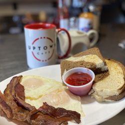 Uptown Cafe - Breakfast combo 3 with two eggs over medium, perfectly crispy bacon, homemade strawberry jam, and homemade rye bread.