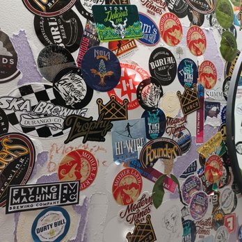 Pour Taproom - Durham - a wall full of stickers - Beer Bar Near Me - Durham, North Carolina