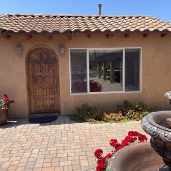Berney Construction - Beautiful custom-built ADU featuring a rustic wooden arched door, stucco exterior, and Spanish-style clay tile roof. - General Contractors Near Me - Riverside, California Berney Construction - Beautiful custom-built ADU featuring a rustic wooden arched door, stucco exterior, and Spanish-style clay tile roof. - General Contractors Near Me - Riverside, California