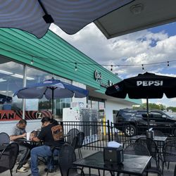 Joe's Kansas City Bar-B-Que - Front of place from outdoor seating; gas pump directly behind us on other side of a fence
