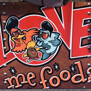 Love Me Foods - a rooster and a chicken on a sign - Food Trucks Near Me - Hurricane, Utah Love Me Foods - a rooster and a chicken on a sign - Food Trucks Near Me - Hurricane, Utah