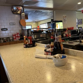 Denny's - a counter with a bowl of pancakes and a plate of pancakes - American Near Me - Raton, New Mexico