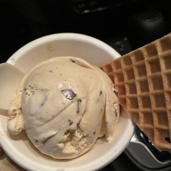 Jeni's Splendid Ice Creams - Salted peanut butter chocolate flakes one scoop in a cup with a slice of the waffle cone. - Ice Cream & Frozen Yogurt Near Me - Austin, Texas
