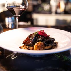 Driven Steakhouse - Red wine braised beef short ribs atop a toasted petite baguette, pickled red onions. Served with a glass of Numanthia Ternes, Tempranillo.