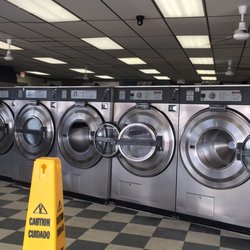 Mr Clean Washateria - Their largest machine costs $6.00 and you can pack in 4 standard + 4 King sized pillows.  I did!!