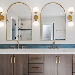 Virtual 360 Media - Timeless elegance: This double vanity features warm wood tones, gold accents, and a stunning blue tile backsplash.