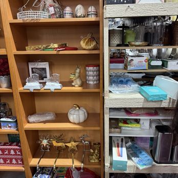 Lodi Junction - Holiday stuff - Wooden and metal shelves display holiday-themed decorations, ornaments, and household goods in a thrift store setting. - Thrift Stores Near Me - Lodi, California