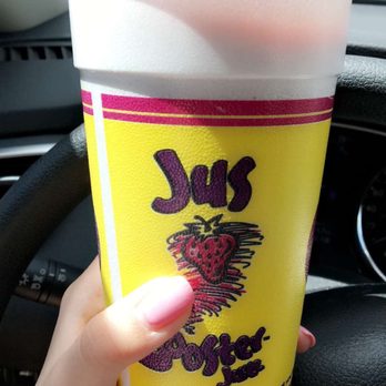 Booster Juice - a hand holding a cup of juice - Juice Bars & Smoothies Near Me - Toronto, Ontario