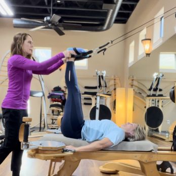 Gentle Physical Therapy - Client working to lengthen her hamstrings with GYROTONIC method tower pulleys - Physical Therapy Near Me - Katy, Texas