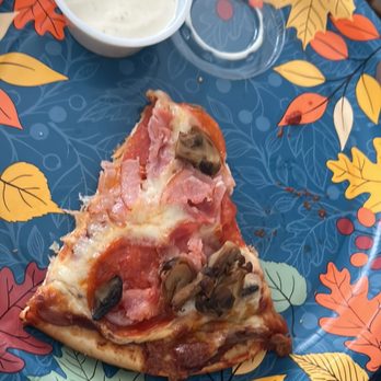 Chuck Wagon - a slice of pizza on a plate - Pizza Near Me - Ludington, Michigan