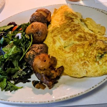 M Italian - Omelet served with little potatoes and "urban" salad. The menu dn state tomatoes but they're in there. Menu said spinach but not one leaf - Diners Near Me - Chagrin Falls, Ohio M Italian - Omelet served with little potatoes and "urban" salad. The menu dn state tomatoes but they're in there. Menu said spinach but not one leaf - Diners Near Me - Chagrin Falls, Ohio