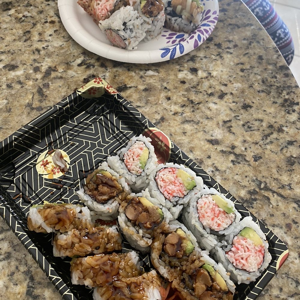 a plate of sushi and a plate of rolls