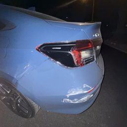 Broken tail light and scratched bumper Broken tail light and scratched bumper