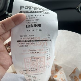 Popeyes Louisiana Kitchen - a person holding a receipt - Fast Food Near Me - Jackson Township, New Jersey Popeyes Louisiana Kitchen - a person holding a receipt - Fast Food Near Me - Jackson Township, New Jersey