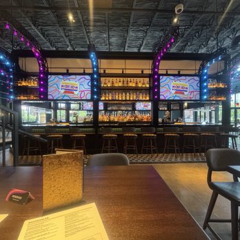 Puttshack - Addison - The lower bar and seating for the restaurant. - Mini Golf Near Me - Addison, Texas