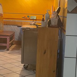 El Patio Mexican Grill - Prep cooler chilling in the middle of the dining room for customers to fish their salsa from.