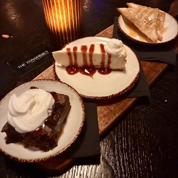 The Conspiracy - Dessert trio - brownie, cheesecake, Apple turnovers - Cocktail Bars Near Me - Charlotte, North Carolina The Conspiracy - Dessert trio - brownie, cheesecake, Apple turnovers - Cocktail Bars Near Me - Charlotte, North Carolina
