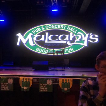 Mulcahy's - a man eating a sandwich - Pubs Near Me - Wantagh, New York