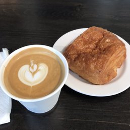 a croissant and a cup of coffee a croissant and a cup of coffee