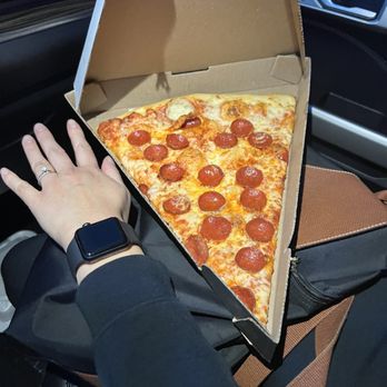 PIE.ZAA - My wife's hand next to a slice to give some perspective of size of the slice. The taste the crunch absolutely amazing pizza! - Pizza Near Me - Asheville, North Carolina PIE.ZAA - My wife's hand next to a slice to give some perspective of size of the slice. The taste the crunch absolutely amazing pizza! - Pizza Near Me - Asheville, North Carolina