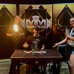Mark Miller with me and my partner posing for a photo by his table set up.