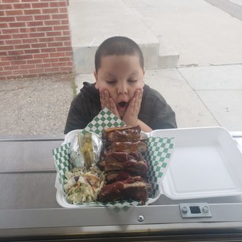 Porky's Chicken - a young boy sitting at a table with a tray of food - Food Trucks Near Me - Denver, Colorado Porky's Chicken - a young boy sitting at a table with a tray of food - Food Trucks Near Me - Denver, Colorado