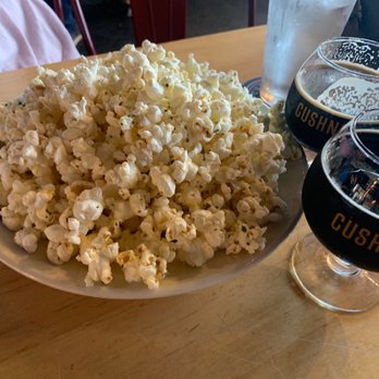 Cushnoc Brewing - Pictured are Garlic Parmesan Popcorn, Belgian Lawyer Up - Belgian Strong Dark Ale and Better than Flowers - a double milk stout - Breweries Near Me - Augusta, Maine