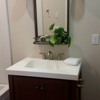 Billman Construction - a bathroom with a sink and mirror - General Contractors Near Me - Hermantown, Minnesota