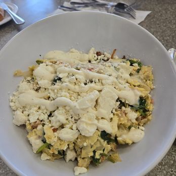 Petite Madeline Bakery & Bistro - Greek bowl - crispy hash browns at the bottom with egg, artichokes, feta, and tomatoes plus a lime crema sauce - Bakeries Near Me - Oceanside, California Petite Madeline Bakery & Bistro - Greek bowl - crispy hash browns at the bottom with egg, artichokes, feta, and tomatoes plus a lime crema sauce - Bakeries Near Me - Oceanside, California