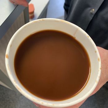 Dunkin' - a person holding a cup of coffee - Donuts Near Me - Newark, New York Dunkin' - a person holding a cup of coffee - Donuts Near Me - Newark, New York
