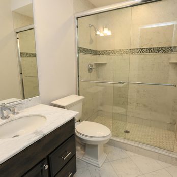 All Scope Construction - a bathroom with a toilet, sink, and shower - General Contractors Near Me