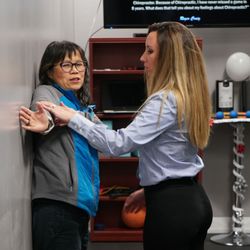 Advanced Health Chiropractic - Dr. Cassie working with a  patient on postural re-education.