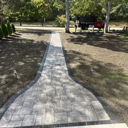 Luxury Landscaping & Hardscaping - New walkway installation and grading the yard .