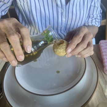 Noor Indian Fusion Kitchen - Pouring the cumin "water" into the puff of the pani puri - Indian Near Me - Berkeley, California Noor Indian Fusion Kitchen - Pouring the cumin "water" into the puff of the pani puri - Indian Near Me - Berkeley, California