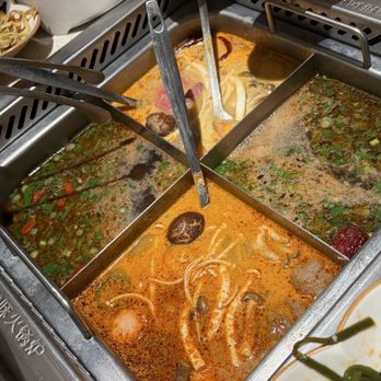 Haidilao - Tom yum, spicy pork bone, and the two water broths with some added sauce - Chinese Near Me - Mesa, Arizona