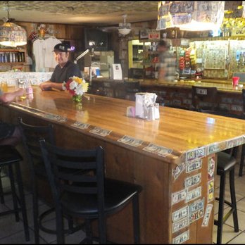 Ski Inn - Michael, sits at the bar, and processes the many dollar bills pasted everywhere, and the several varities of beer on tap. - American Near Me - Niland, California Ski Inn - Michael, sits at the bar, and processes the many dollar bills pasted everywhere, and the several varities of beer on tap. - American Near Me - Niland, California