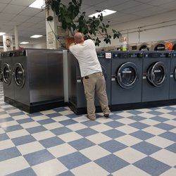 Blue Lagoon Laundry - Mgr cleaning the machines at night, which shows as this place is sparkling clean
