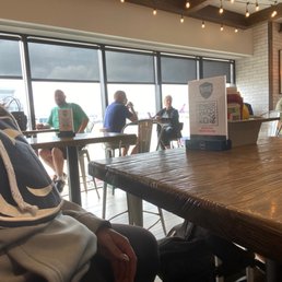 a man sitting at a table with a laptop a man sitting at a table with a laptop