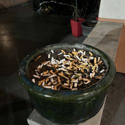 Overflowing cigarette butts on the patio.