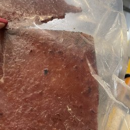 a piece of meat wrapped in plastic a piece of meat wrapped in plastic