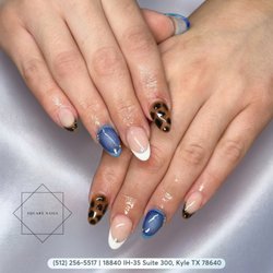 Unleash your wild side with a flawless mix of fierce leopard spots, classic white French tips, and deep denim blue cat-eye sheen. Book!