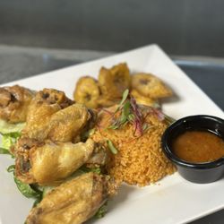 Zola Cultural Kitchen - Chicken Wings and Jollof Rice with side fried Plantains and Hott sauce