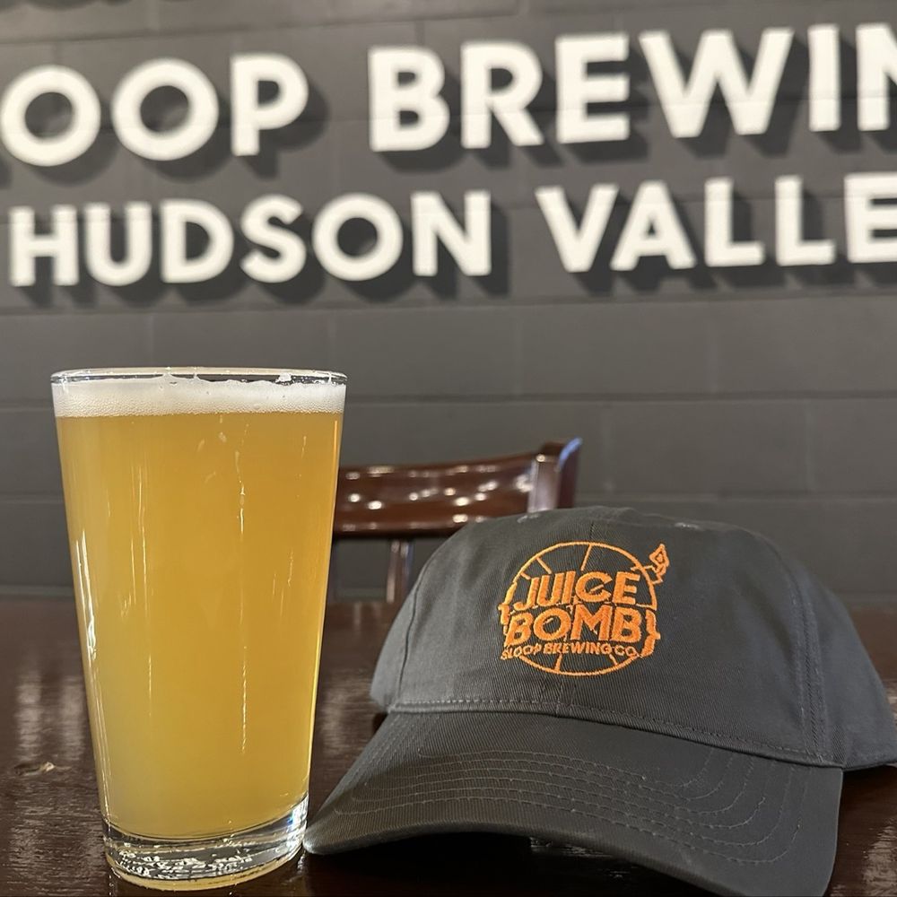 Sloop Brewing @ the Factory - Juice Bomb beer with hat - Breweries Near Me - Hopewell Junction, New York Sloop Brewing @ the Factory - Juice Bomb beer with hat - Breweries Near Me - Hopewell Junction, New York