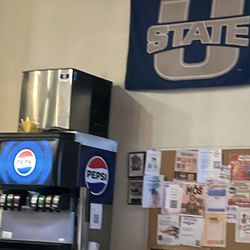 Beverage and U State flag with bulletin board of happenings