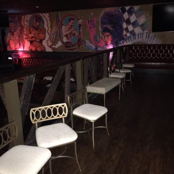 Dead Poet - a row of white chairs in a dimly lit room - Bars Near Me - Baton Rouge, Louisiana Dead Poet - a row of white chairs in a dimly lit room - Bars Near Me - Baton Rouge, Louisiana