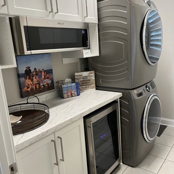 Artisan Custom Closets - Laundry room with unseen hanging space on right side of washer/dryer - Interior Design Near Me - Marietta, Georgia