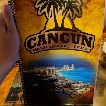 Cancun Mexican Restaurant - a hand holding a book - Mexican Near Me - Cincinnati, Ohio Cancun Mexican Restaurant - a hand holding a book - Mexican Near Me - Cincinnati, Ohio