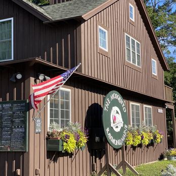 The Mosquito - a brown building with a sign and a flag - Ice Cream & Frozen Yogurt Near Me - Raymond, Maine