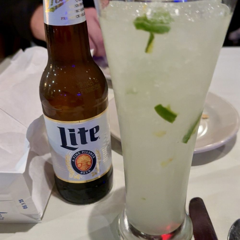Opus Ocean Grille - Flaming Coconut Cocktail  and Miller Lite - Seafood Near Me - Clear Lake Shores, Texas