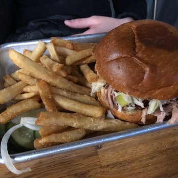 Bubba’s Bones & Brews - Pulled pork sandwich. Smaller than looks. That's a child's hand. Lacked flavor and saus sadly. Mostly bread - Gastropubs Near Me - Cathedral City, California